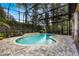 Inviting kidney-shaped pool with a screened enclosure and water feature at 600 Via Chris Ct, Debary, FL 32713