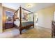 Main bedroom with carpeted floors and a four-poster bed at 600 Via Chris Ct, Debary, FL 32713