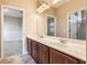 Double vanity bathroom with marble countertop and dark wood cabinets at 600 Via Chris Ct, Debary, FL 32713