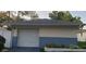 Detached garage with white door, light beige walls, and blue brick base at 4721 Watch Hill Ct, Orlando, FL 32808