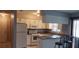 Galley kitchen with white cabinets, granite counters, and appliances at 4721 Watch Hill Ct, Orlando, FL 32808