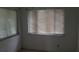Small bedroom with two windows and mini blinds at 4721 Watch Hill Ct, Orlando, FL 32808