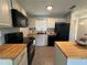 Kitchen with butcher block countertops and black appliances at 5937 Colchester Dr, Orlando, FL 32812