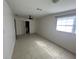 Spacious living room with tile floors and access to laundry and exterior at 5937 Colchester Dr, Orlando, FL 32812