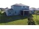 Two-story house with a screened patio and a grassy backyard at 4813 Terra Sole Place, St Cloud, FL 34771
