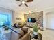 Relaxing living room with brown leather sofas and a stone accent wall at 4813 Terra Sole Place, St Cloud, FL 34771