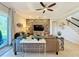 Living room with stone feature wall, comfortable seating, and large screen TV at 4813 Terra Sole Place, Saint Cloud, FL 34771