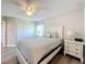 Comfortable bedroom with a queen bed, white dresser, and large window at 4813 Terra Sole Place, St Cloud, FL 34771
