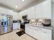 Bright kitchen featuring stainless steel appliances and white cabinets at 4813 Terra Sole Place, St Cloud, FL 34771