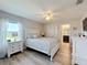 Cozy bedroom with a queen bed, white dresser, and en-suite bathroom at 4813 Terra Sole Place, St Cloud, FL 34771