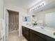 Bathroom with double vanity, large mirror, and shower/tub combo at 4813 Terra Sole Place, St Cloud, FL 34771