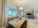 Bright dining area with wooden table, gray chairs and view into living room at 4813 Terra Sole Place, St Cloud, FL 34771