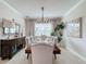 Elegant dining room with a large table, chandelier, and neutral decor at 4813 Terra Sole Place, St Cloud, FL 34771