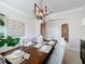 Elegant dining room with a large table, chandelier, and neutral decor at 4813 Terra Sole Place, St Cloud, FL 34771