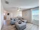 Open living area featuring a sectional sofa and ample natural light at 4813 Terra Sole Place, St Cloud, FL 34771