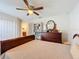 Bedroom with a king-size bed, dresser, and bookcase at 4813 Terra Sole Place, St Cloud, FL 34771