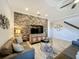 Living room with stone accent wall, comfortable seating and large TV at 4813 Terra Sole Place, St Cloud, FL 34771