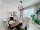 Elegant dining room with a large table, chandelier, and neutral decor at 4813 Terra Sole Place, St Cloud, FL 34771