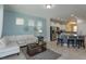 Living room with sectional sofa and kitchen view at 5295 Wildwood Way, Davenport, FL 33837