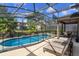 Screened pool and spa with patio furniture and fenced yard at 5295 Wildwood Way, Davenport, FL 33837