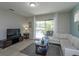 Living room with sectional sofa and pool view at 5295 Wildwood Way, Davenport, FL 33837