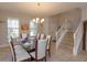 Bright dining room with a glass table and staircase view at 5295 Wildwood Way, Davenport, FL 33837