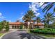 Community center with Spanish tile roof and landscaping at 5295 Wildwood Way, Davenport, FL 33837