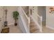 Stylish staircase with white railings and carpeted steps at 5295 Wildwood Way, Davenport, FL 33837