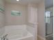 Bathroom with garden tub and walk-in shower at 5295 Wildwood Way, Davenport, FL 33837