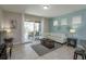 Bright living room with comfy seating and view of patio at 5295 Wildwood Way, Davenport, FL 33837