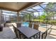 Enjoy dining alfresco overlooking the pool and spa from under the screened patio at 5295 Wildwood Way, Davenport, FL 33837