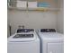Laundry room with washer, dryer, and shelving at 5295 Wildwood Way, Davenport, FL 33837