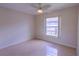 Simple bedroom with tile floors and a window with backyard view at 5631 La Joya Ct, Orlando, FL 32808