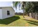 View of the home's exterior and backyard with a palm tree at 5631 La Joya Ct, Orlando, FL 32808