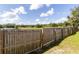 Backyard with a partially damaged wooden fence and a pond view at 5631 La Joya Ct, Orlando, FL 32808