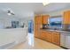 Bright kitchen with wood cabinets, tile floor, and stainless steel dishwasher at 5631 La Joya Ct, Orlando, FL 32808