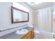 Clean bathroom with a shower/tub combo, gray tile accent, and wood vanity at 5631 La Joya Ct, Orlando, FL 32808
