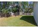 Backyard view showcasing a grassy area and wooden fence at 5631 La Joya Ct, Orlando, FL 32808