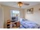 Bedroom with a desk, bed, and window overlooking a tranquil landscape at 5631 La Joya Ct, Orlando, FL 32808