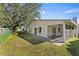 Home exterior showcasing screened porch and yard at 39 Chip Ct, Kissimmee, FL 34759