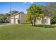 Two-story house with a two-car garage and palm tree in the front yard at 39 Chip Ct, Kissimmee, FL 34759