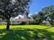 One-story house with a manicured lawn and large oak tree at 2800 Tropic Ct, Winter Garden, FL 34787
