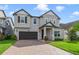 Two-story house with gray siding, dark brown garage door, and a brick driveway at 3149 Jade Tree Pt, Oviedo, FL 32765