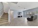 Open living room with tile floors and staircase at 3149 Jade Tree Pt, Oviedo, FL 32765