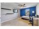 Bedroom with a blue accent wall and a desk area at 3149 Jade Tree Pt, Oviedo, FL 32765