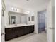 Bathroom with double vanity and a blue and white shower curtain at 3149 Jade Tree Pt, Oviedo, FL 32765