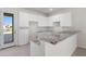 Modern kitchen with white cabinets and granite countertops at 164 Holly Village Dr, Davenport, FL 33837