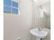 Small bathroom with pedestal sink and mirror at 164 Holly Village Dr, Davenport, FL 33837