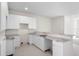 Modern kitchen with white cabinets and granite countertops at 164 Holly Village Dr, Davenport, FL 33837