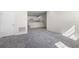 Bright living room with grey carpet and view to kitchen at 164 Holly Village Dr, Davenport, FL 33837